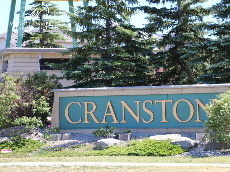 Cranston Calgary entrance sign surrounded by mature trees and landscaping