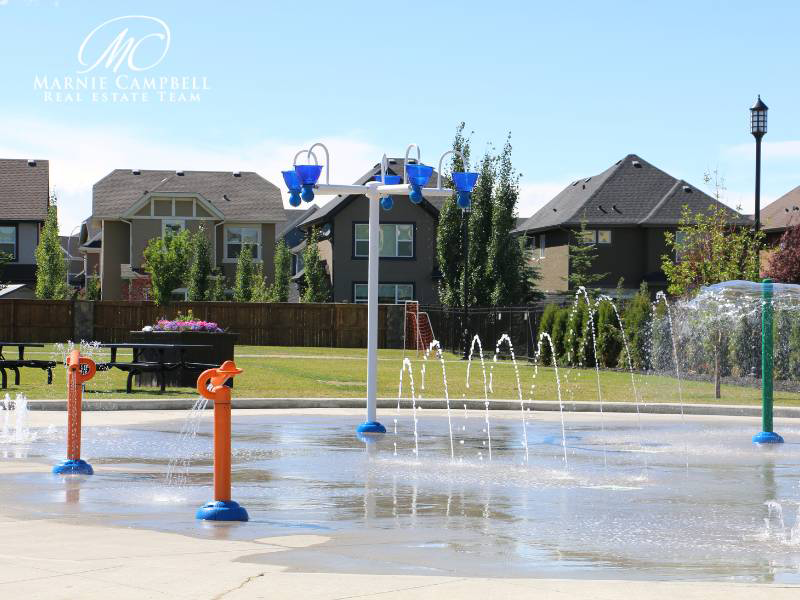 Children’s splash park in Cranston, Calgary, surrounded by family homes and picnic benches