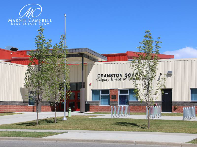 Cranston School in southeast Calgary with bike racks and trees in front of the entrance