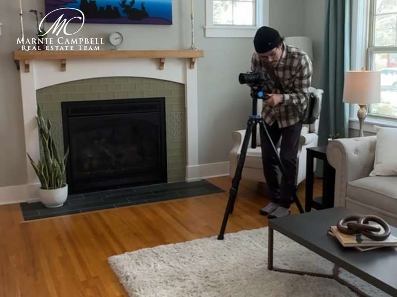 Professional real estate photographer setting up camera in Glamorgan living room