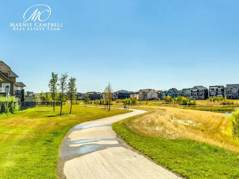 Scenic pathway through Mahogany Calgary with homes and green space in the background